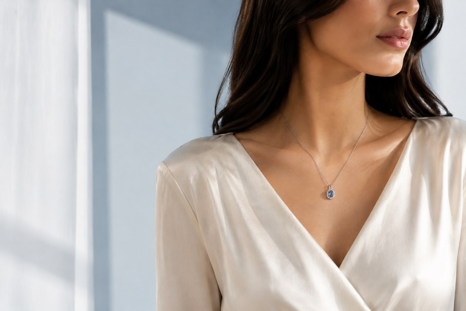 Woman wearing a pale blue gemstone Crystaro necklace